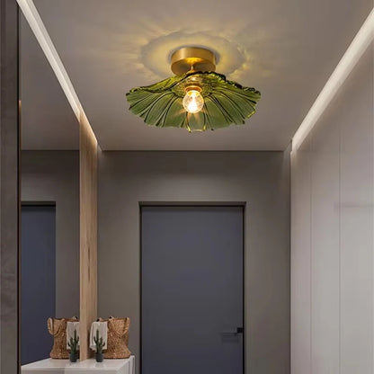 Green petal glass ceiling light mounted in a hallway