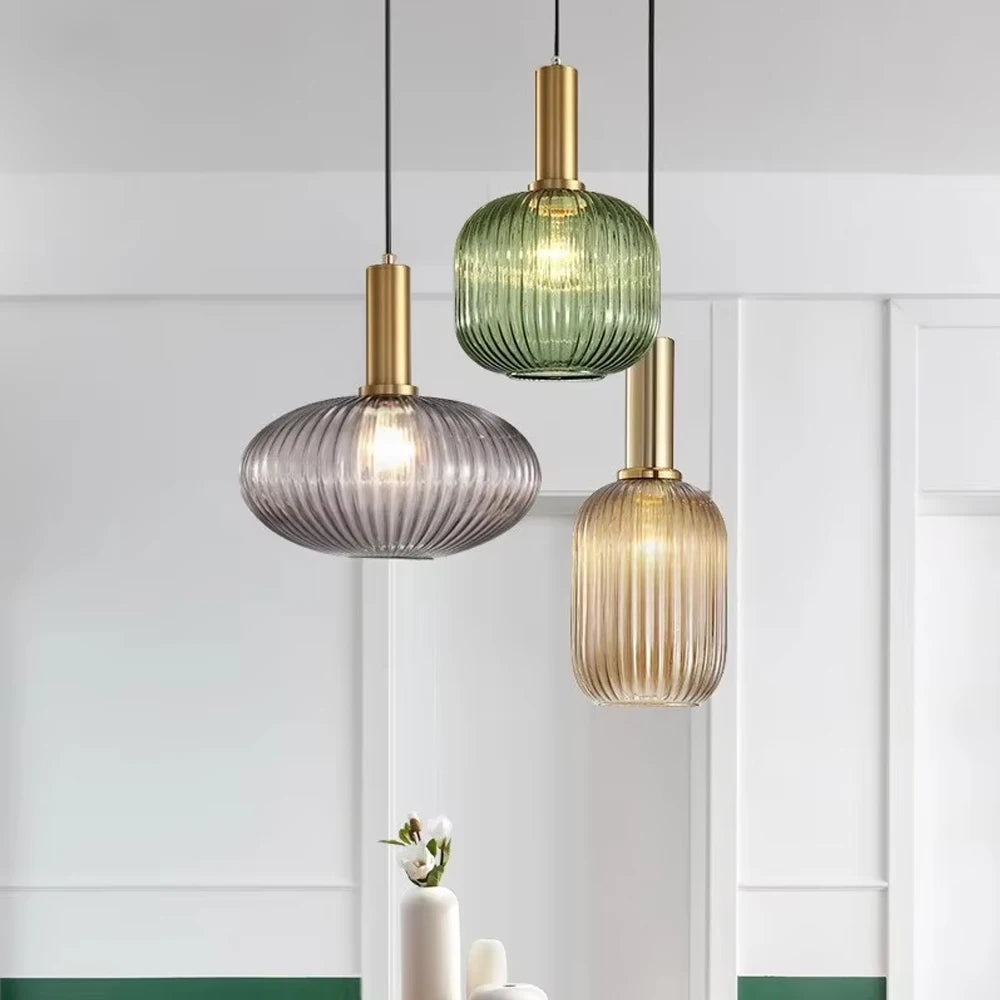 Three ribbed glass pendant lights in smoke grey, green and amber