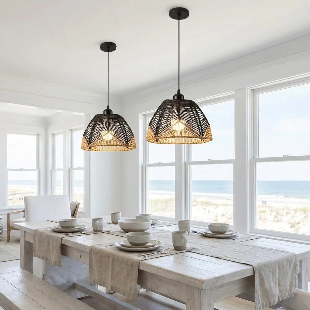 Two woven dome pendant lights above a dining table beside a window