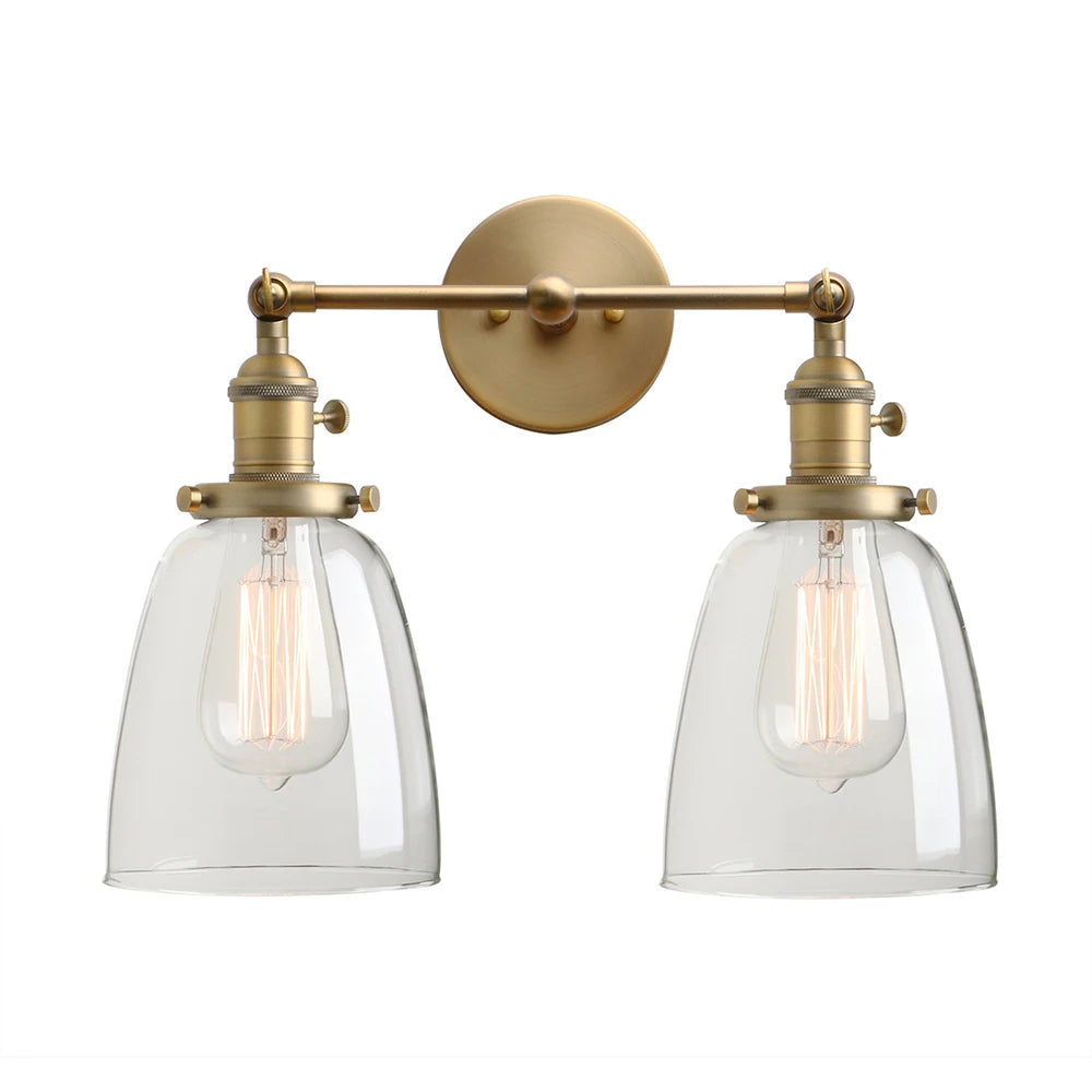 Twin bell brass wall sconce with two clear glass shades on one backplate