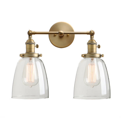 Twin bell brass wall sconce with two clear glass shades on one backplate